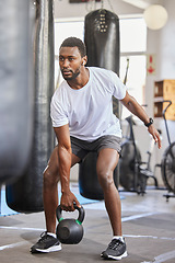 Image showing Exercise, kettlebell and black man doing fitness with a weight with strength, focus and motivation. Sports, exercising and strong African male athlete doing muscle training or workout at a gym