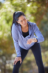 Image showing Fitness, tired and woman with smart watch at park for running time, performance and cardio exercise outdoors. Female runner check stopwatch, clock and monitor heart rate, breathing and body wellness