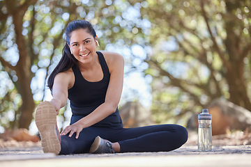 Image showing Fitness, runner and portrait of woman stretching on park floor with music, podcast or motivation audio for wellness. Face, athlete and girl stretch on ground in nature for training, run and exercise