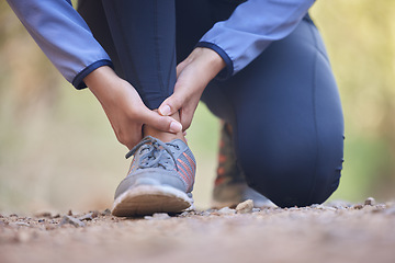 Image showing Running, ankle pain and injury with shoes of black woman on nature trail for training, jogging and endurance. Sprain, accident and broken with girl runner on path for workout, exercise and sports