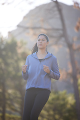 Image showing Woman, running and runner on nature run in forest for healthy fitness exercise, outdoors cardiovascular workout and sports training. Jog in green woods, natural trees and motivation for cardio health