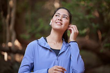 Image showing Forest, fitness and woman listening to music for nature calm, peace and zen podcast with inspiration for sports training, hiking or running. Happy woman or athlete with audio technology in the woods