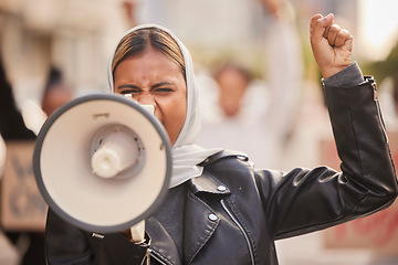 Image showing Freedom, megaphone and fist with muslim woman in protest for support, social justice and human rights activist. Politics, revolution and equality with hijab girl in crowd for discrimination fight