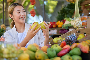 Image showing Woman, fruit and grocery shopping in outdoor market, pear choice and health product with food and nutrition in Seoul marketplace. Store, happy Asian customer and retail with sale, vegetable and smile