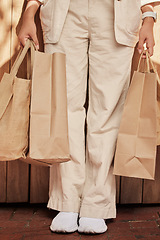 Image showing Sustainability, fashion paper bag and woman legs for eco friendly, vegan and designer retail clothes in shopping, commerce and economy. Sustainable market, sale and discount of customer bag in hands