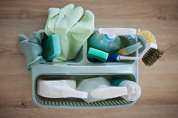 Image showing Top view of cleaning, products and basket on table in home living room for hygiene. Spring cleaning, health or housekeeping equipment, tools or supplies to disinfect or remove dust, germs or bacteria