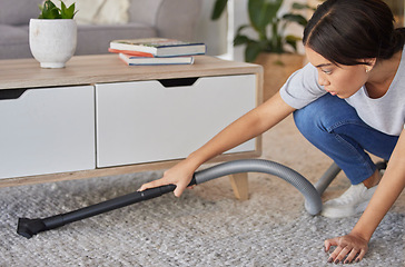 Image showing Woman, cleaning and vacuum machine for carpet in house, home or hotel living room in hygiene maintenance or housekeeping. Maid, cleaner service or worker with suction on floor rug for spring cleaning