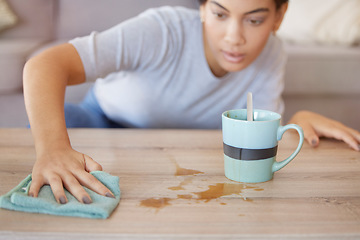 Image showing Cleaning surface, coffee spill and woman wipe furniture, coffee table and counter in living room with cloth. Housekeeping, hygiene and young woman with rag for liquid mess, dirt and stain from tea