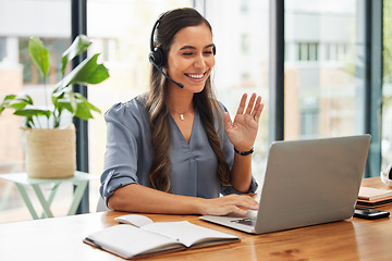 Image showing Video call, business woman and wave on laptop with headphones for communication, virtual meeting and global consulting in startup company. Happy female worker, smile and hello on computer conference