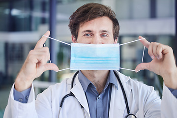 Image showing Healthcare, face mask and portrait of doctor in a hospital standing in the lobby after a consultation. Covid regulations, pandemic and surgeon with mask working in medicare clinic or center in Canada