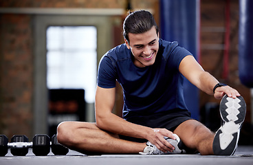 Image showing Fitness, man and stretching legs in gym for health, mobility and flexibility. Sports, wellness and happy male warm up or preparing for training, exercise or workout in fitness center for healthy body