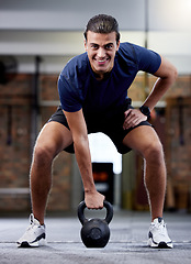Image showing Workout, exercise and man with kettlebell in gym for muscle strength, health and wellness. Fitness, sports and portrait of male athlete from Canada with weight for lifting, training and exercising.