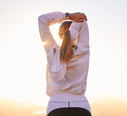 Image showing Fitness, workout and woman stretching before running hiking or marathon training from back at sunset. Health, wellness and sports, stretch motivation to exercise for girl hiker, athlete or runner.