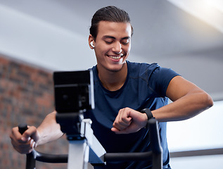 Image showing Fitness, bike and man doing workout at the gym for cardio endurance, health and wellness. Sports, electric bicycle and healthy male athlete training or doing exercise with smart watch in sport center