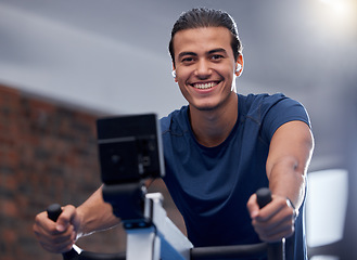 Image showing Man, fitness and cycling at the gym for exercise, workout or healthy cardio training. Portrait, happy smile or exercising on stationary bicycle or bike machine for health, wellness or endurance sport