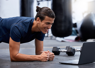 Image showing Exercise, laptop and personal trainer do virtual workout video on internet streaming or watching tutorial for fitness. Content creator or influencer man at gym for pushup or plank training online