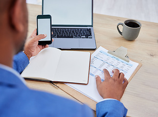 Image showing Phone, laptop and mockup of man finance planning, budget and fintech for banking, loan or mortgage application. Accounting, website and management black man with financial, tax and invoice documents