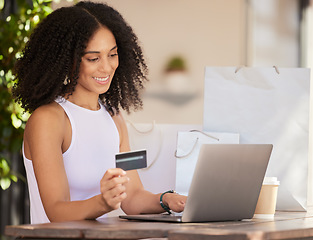 Image showing Black woman, laptop and credit card for ecommerce, online shopping and making payment with fintech software while at a cafe with wifi connection. Female customer in Paris doing internet banking