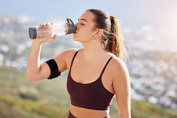 Image showing Water, fitness and drink water after hiking, workout and challenge for health, wellness or nutrition. Young sports, athlete or runner woman with water bottle for exercise, training or hydrate outdoor