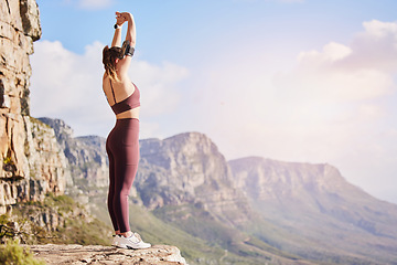Image showing Fitness, hiking and woman on mountain stretching, meditation and training in nature for healthy lifestyle. Health, wellness and workout for girl on cliff, yoga exercise on rock for hike in mountains.