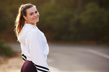 Image showing Woman runner, street and nature for portrait, smile and fitness in summer for health with blurred background. Happy athlete, marathon training and running workout for wellness, self care and exercise