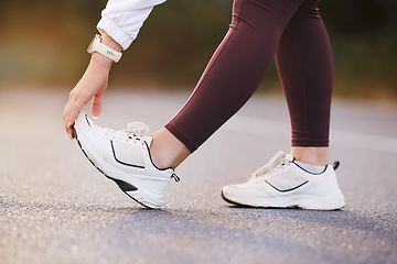 Image showing Feet, fitness and stretching woman in street for running, outdoor training and exercise with sneakers, shoes or sports gear marketing. Hand, foot and sports, athlete or runner on road for workout