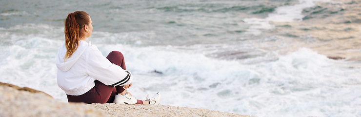 Image showing Beach, woman and relax for peace and thinking on rock for calm positive mindset, watching ocean waves or freedom vision outdoor. Zen meditation, mindfulness and mental health at Sydney seaside