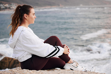 Image showing Woman, beach and thinking about future, freedom and life on a rock with zen, peace and calm ocean for mindfulness, meditation and mental health. Female at sea to relax on nature holiday in Sydney
