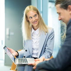 Image showing Business meeting. Client consulting. Confident business woman, real estate agent, financial advisor explaining details of project or financial product to client in office.