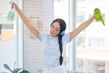 Image showing Woman cleaning, dancing and listening to music with headphones while holding cloth and detergent to clean with energy, fun and audio podcast. Female cleaner or maid working in a house or apartment