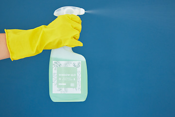 Image showing Hand, spray and detergent for cleaning, hygiene or anti bacteria chemical against a blue studio background. Hands of glove spraying liquid bottle for washing, clean sanitary or disinfection on mockup