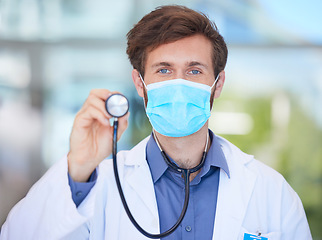 Image showing Covid, cardiology and portrait of doctor with stethoscope to check, test and measure heart rate in clinic. Healthcare, face mask and male cardiologist for heart health, wellness and medical care