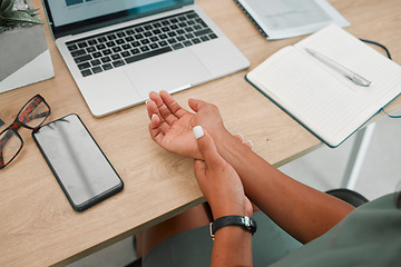 Image showing Wrist, arm and pain by laptop desk of employee worker suffering from carpal tunnel syndrome at the office. Person hand holding painful area, inflammation or sore muscle ache from working on computer