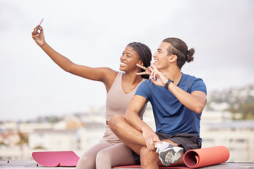 Image showing Couple, fitness and selfie with a peace sign after exercise for a social media post or blog update while outdoor in city with a smile and support. Man and black woman together for a workout in France