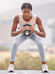 Image showing Rooftop fitness, kettlebell and black woman training for sports, body motivation and urban workout in the city of Turkey. Exercise, strength training and portrait of an African athlete with weights