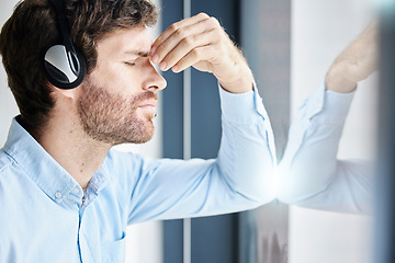 Image showing Headache, stress and call center man in office feeling exhausted, tired or fatigue. Crm, customer service and male telemarketing consultant with depression, anxiety and burnout in company workplace.