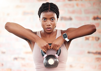 Image showing Black woman, fitness and kettlebell with focus and exercise in gym, weights and muscle training with strong athlete and bodybuilding. Bodybuilder, workout and sport motivation with wellness portrait.