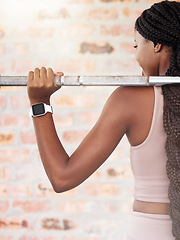 Image showing Back, black woman and lifting for exercise, workout and training for health, wellness and power. Jamaican female, healthy lady and athlete weightlifting, practice and fitness for endurance and energy