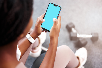 Image showing Fitness, smartphone in hands and mockup with green screen, black woman and app for exercise and weightlifting with dumbbell in gym. Sports marketing, wellness and phone with virtual workout class.