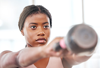 Image showing Fitness, kettlebell and black woman doing an exercise with a weight with strength, focus and motivation. Sports, exercising and strong African female athlete doing muscle training or workout at a gym