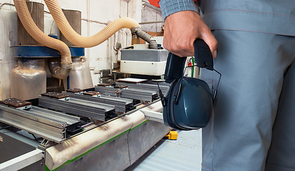 Image showing Worker with headphones