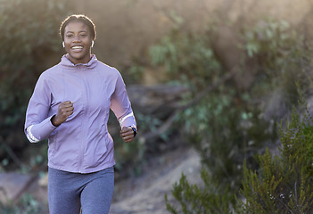 Image showing Black woman, running and fitness of a runner happy about nature workout and sport. Training motivation, cardio and exercise for a marathon run on a mountain bush hiking path outdoor for health