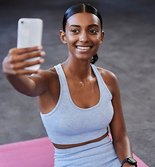 Image showing Fitness selfie, sports floor and woman with social media post, profile picture update or wellness website blog on mobile app. Smartphone photography, Indian athlete and pilates or cardio gym training