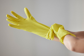 Image showing Hands, yellow rubber gloves and cleaning woman ready for worker cleaning service, spring cleaning or housework in studio background. Maid, hygiene safety wellness and bacteria maintenance uniform