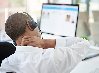 Image showing Call center, advice and neck pain with a man feeling body ache while in a telemarketing and communication job. Burnout, stress and physical strain in a contact us, customer care and consulting agency