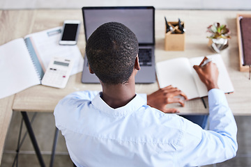 Image showing Top view, black man and writing with laptop, planning schedule and online reading in office. Nigerian male, entrepreneur and make notes for marketing strategy, search internet and ideas for business.