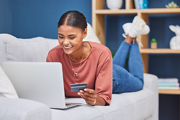 Image showing Credit card, laptop and woman relax on sofa online shopping, ecommerce website and shop fashion sale in living room. Black woman, happy customer and digital tech purchase with bank card or bank app