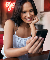 Image showing Phone, social media and communication with a black woman in a coffee shop or internet cafe to relax alone. Contact, mobile and social network with a young female sitting in a restaurant or bistro