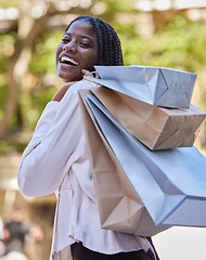 Image showing Black woman, portrait and fashion retail shopping satisfaction with deal, discount and choices. Customer, happiness and smile of girl walking with clothes boutique shopping bags in South Africa.