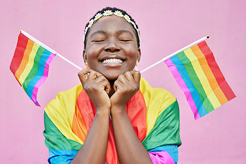 Image showing Pride, lgbtq and black woman with flags in studio for queer rights. Freedom, homosexual and face of happy, lesbian or bisexual female from Nigeria with rainbow flag showing support for gay community.